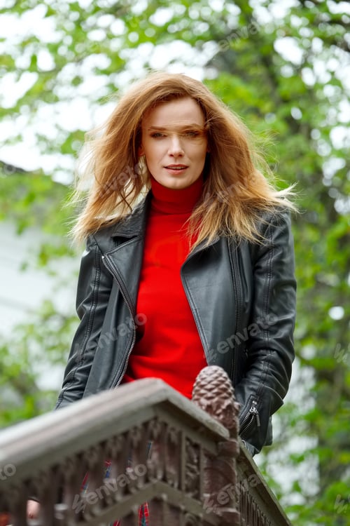 Preview: portrait of red hair lady in leather jacket with cardboard cup in hand