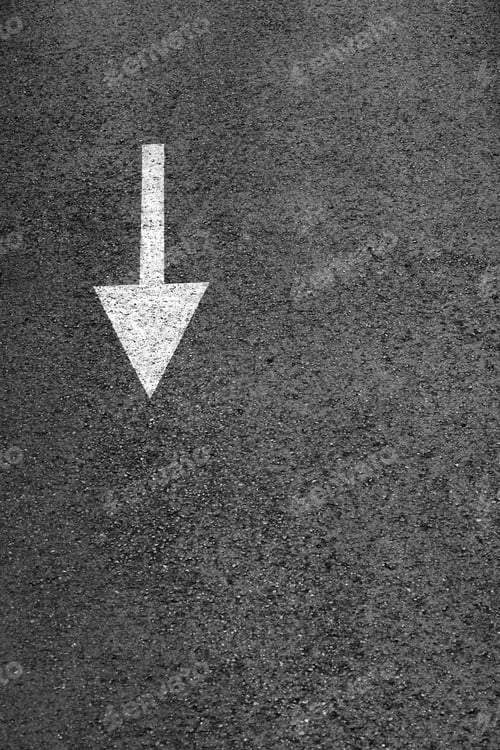 Preview: White arrow on the dark gray asphalt