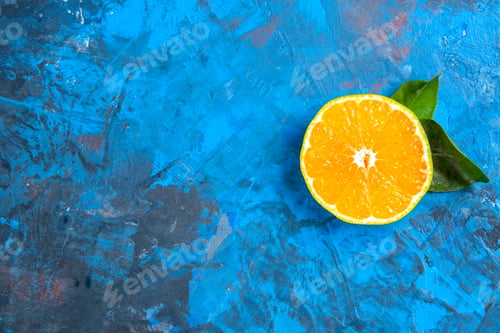 Preview: top view cut orange on blue background free place