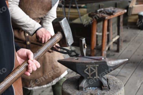 Preview: Father and son small business manual metalworking. a small blacksmith shop
