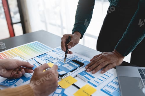 Preview: ux developers, UI designers Asian group data researchers brainstorm on tabletop mobile app interface