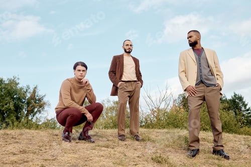 Preview: Stylish male models showcase autumn fashion in a serene natural field setting