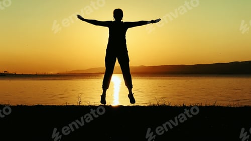 Preview: Woman Silhouette With Open Arms At Sunset Beach at Sunset
