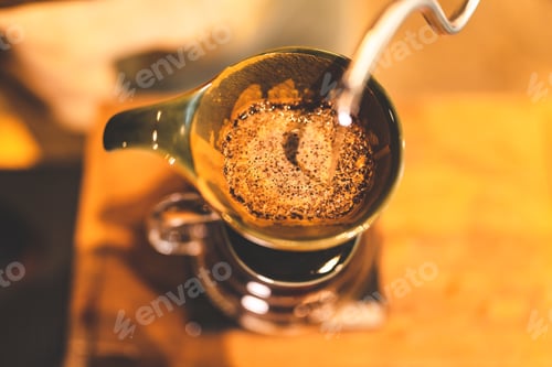 Preview: Asian hipster barista working to make a coffee by slow bar process, coffee filter or drip brewing