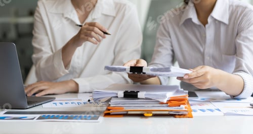 Preview: Colleagues businesswoman discussing business project project documents in office.