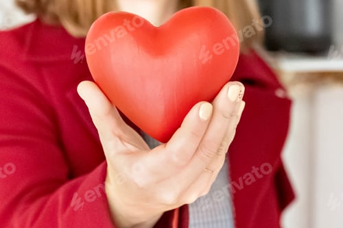 Preview: A red heart in a woman's hands. A symbol of love. Valentine's day