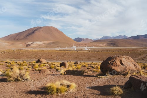 Preview: Dry landscape shot of field full of geysers. El Tatio geysers in Atacama desert, Chile.