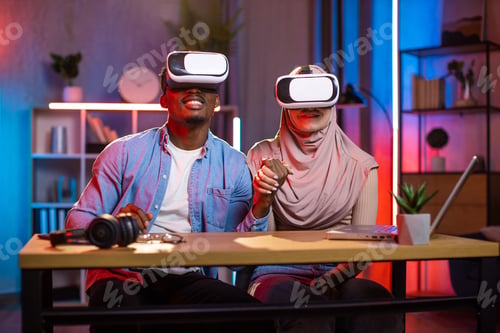 Preview: Multiracial couple in VR glasses playing games at home