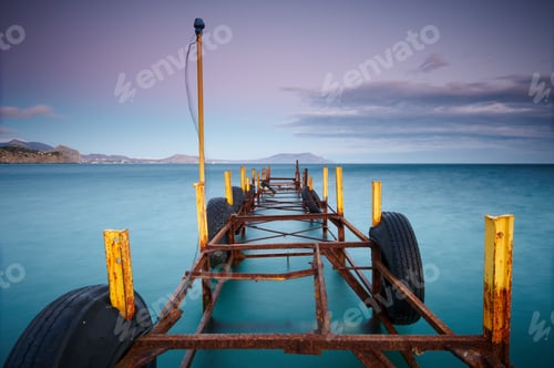 Preview: Abandoned jetty on sea sunset and sky reflection water.