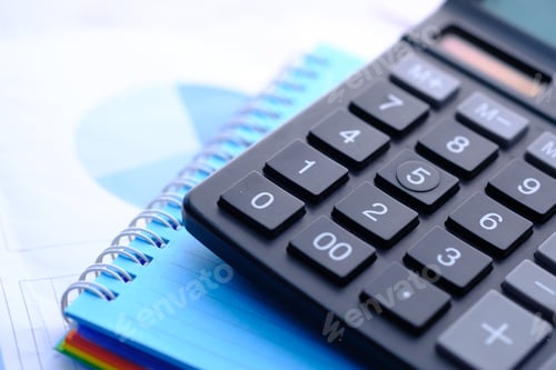 Preview: Close up of blue calculator and notepad on color background