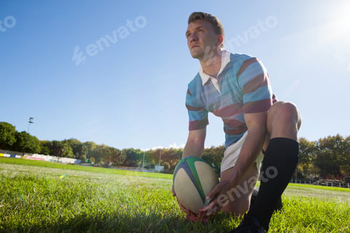 Preview: Low angle view of rugby player getting ready to kick for goal