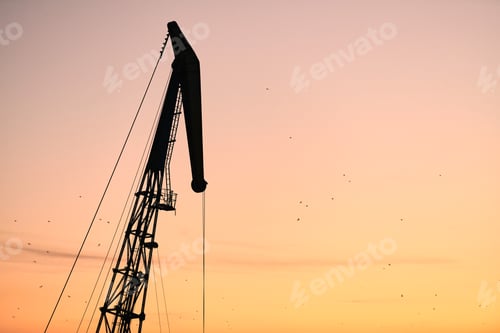 Preview: Silhouette of container crane on sunset background