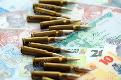 Preview: Nigerian naira currency money bills and rifle bullets. The concept of warfare and gun selling