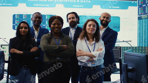 Preview: Diverse group of business professionals posing together in monitoring room