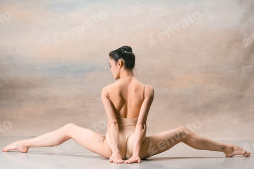 Preview: The ballerina is sitting with her back legs wide apart