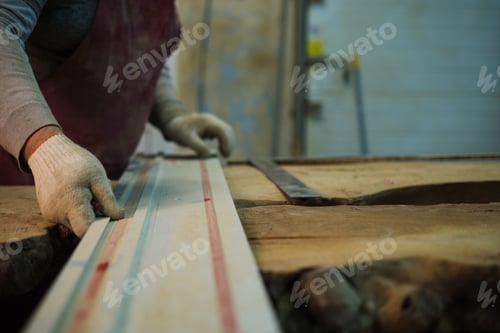 Preview: A woodworker's precise measurement, detail emphasized. Resonates with the DIY movement's push for
