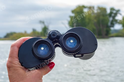 Preview: Closeup of woman’s hand holding binoculars