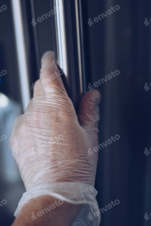 Preview: Hand in Protective Glove Touching Metal Railing