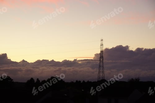 Preview: Electric post against thick clouds