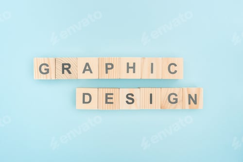 Preview: top view of graphic design lettering made of wooden cubes on blue background