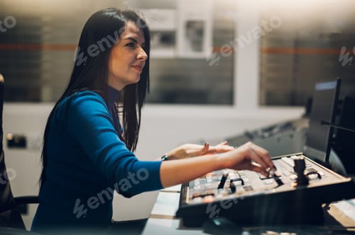 Preview: Middle aged woman using equipment in control room on a tv station