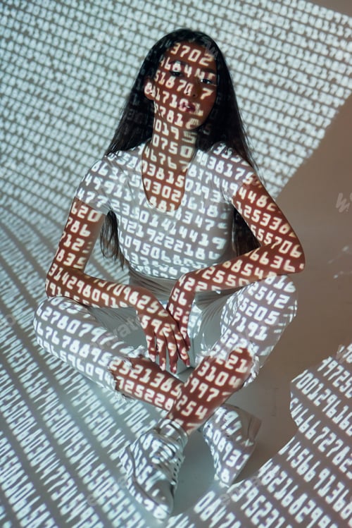 Preview: Many of the different numbers. Beautiful young woman is in projector neon lights in the studio