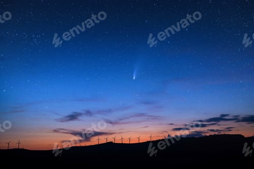 Preview: Landscape of hills with windmills under a starry sky in the evening on the background