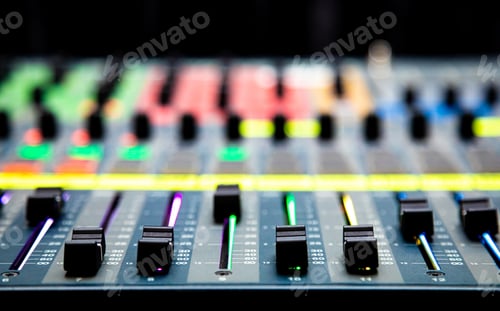 Preview: Closeup shot of sliders and buttons on an audio mixing desk at a live event