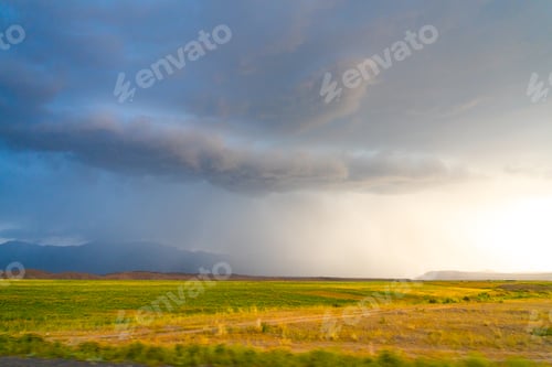 Preview: Dramatic sky over a vast green plain