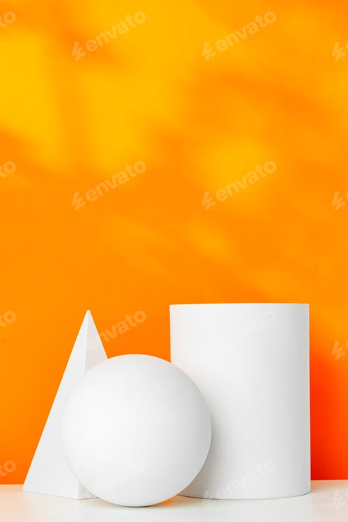 Preview: White geometric shapes on a vibrant orange background with soft shadows in a well-lit indoor setting