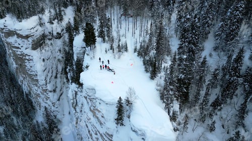 Aperçu: Winter mountain cliff covered by snow, ice, and fur trees. Clip. Stunning frozen winter nature