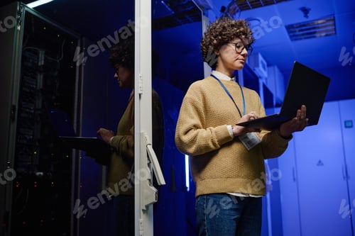 Preview: Female engineer examining data on laptop