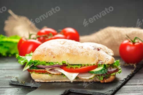Preview: Ciabatta sandwich with fresh tomatoes on a black slate plate