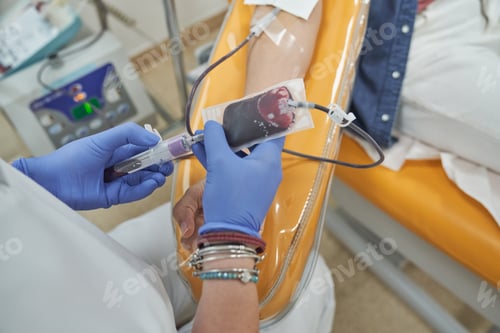 Preview: Crop doctor and female patient during blood donation in clinic
