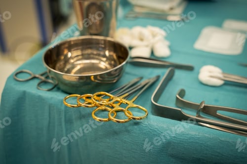 Preview: Surgical Instruments Laid Out on Green Tablecloth