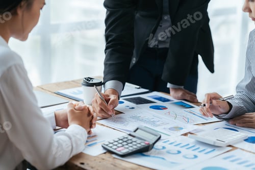 Preview: Business people working in the office discussing documents and ideas at meeting.