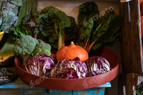 Preview: A variety of fresh vegetables displayed in a bowl with pumpkin, lettuce and broccoli