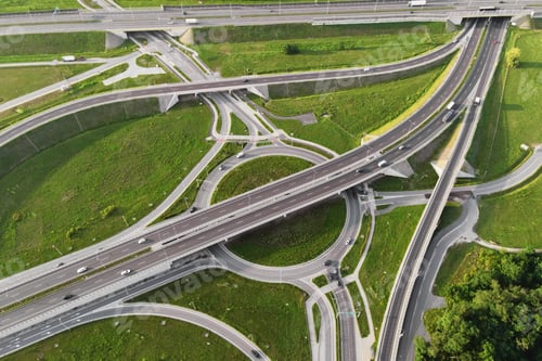 Preview: Cars moving on transport road junction in city, aerial view