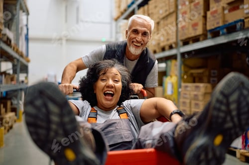 Preview: Cheerful warehouse workers having fun at work.