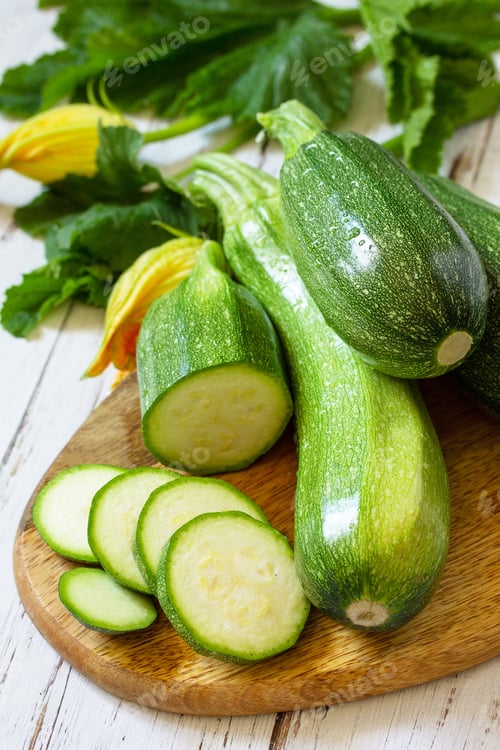 Preview: Fresh healthy green zucchini on a wooden kitchen table.