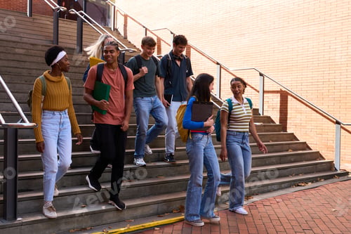 Preview: Diverse students walking down university stairs together