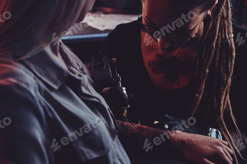 Preview: Process of tattoo making at dark photo studio