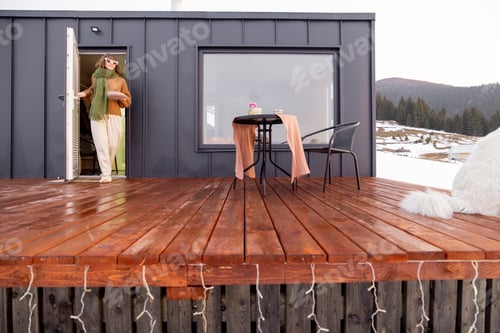 Preview: Woman resting at small house in the mountains