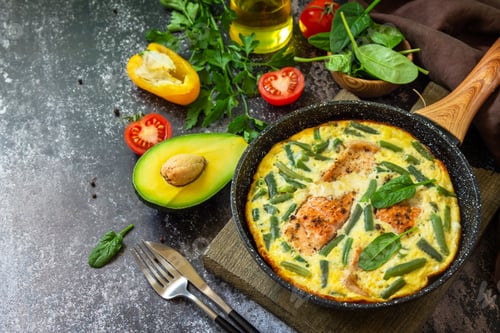 Preview: Breakfast or lunch snack concept. Rustic omelet with salmon fillet and green beans.