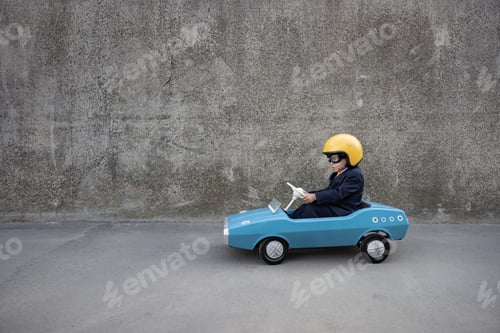 Preview: Funny businessman driving retro pedal car outdoor