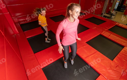 Preview: Happy family having fun while jumping on trampoline