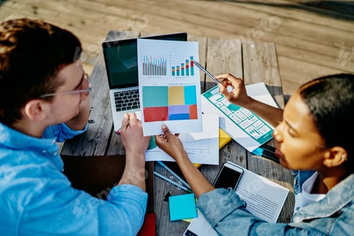 Preview: Young Adults Collaborate Reviewing Business Data