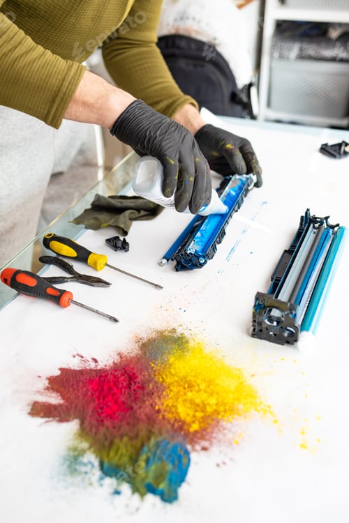 Preview: Printer technician engineer is refilling a laser toner cartridge. Office equipment maintenance conce