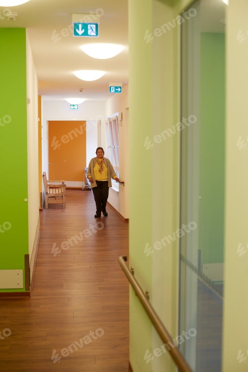 Preview: Age demented senior woman on corridor in a nursing home