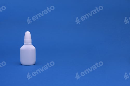 Preview: Nasal spray close-up on a blue background. mock up